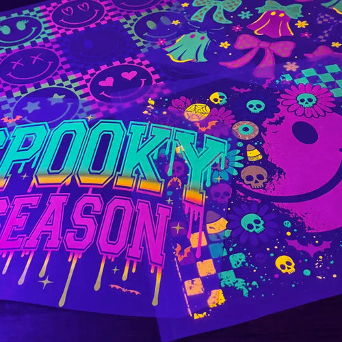 Blacklight reactive Halloween-themed fabric with glow-in-the-dark designs.