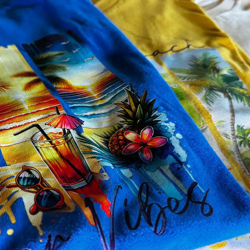Blue and yellow patterned t-shirts with a tropical beach design.