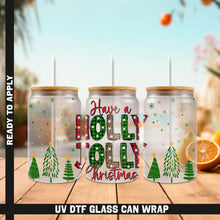 Load image into Gallery viewer, a group of three holiday cans sitting on top of a wooden table
