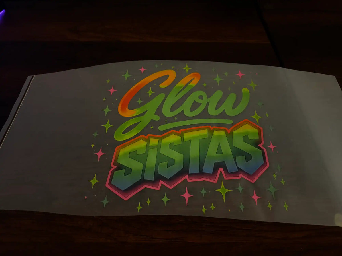 Colorful ’Glow Sistas’ graphic design on a translucent sheet.