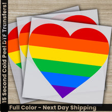 Load image into Gallery viewer, a pair of rainbow heart stickers on top of a wooden table
