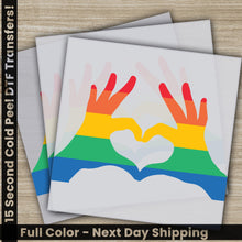 Load image into Gallery viewer, a pair of hands making a heart with the colors of the rainbow
