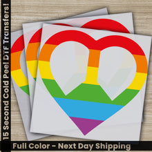 Load image into Gallery viewer, a pair of rainbow heart stickers on top of a wooden table
