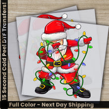 Load image into Gallery viewer, a christmas card with a santa clause holding a string of lights
