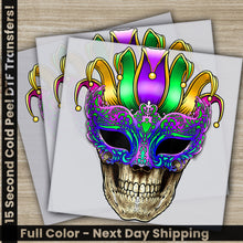 Load image into Gallery viewer, a skull wearing a colorful mask on top of two sheets of paper