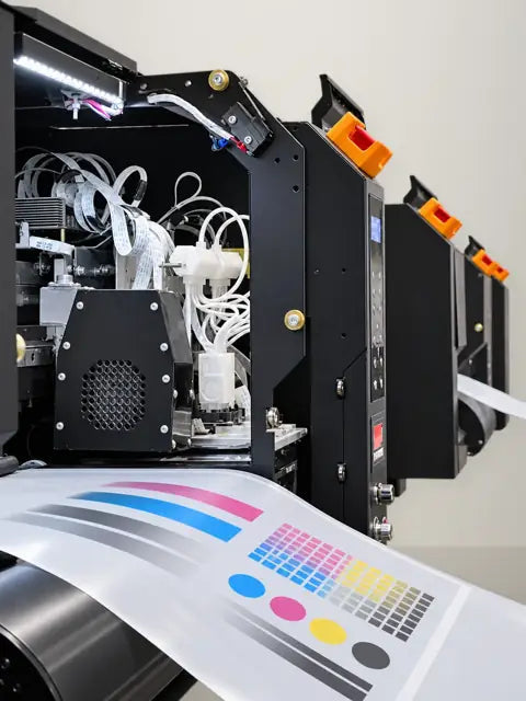DTF print head printing a CMYK and white color test strip on transfer film